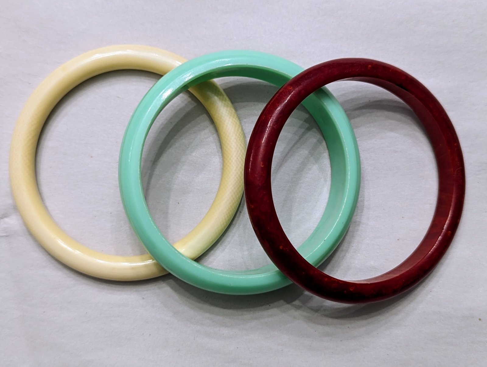 Red Bakelite Plus Two Plastic Bracelets